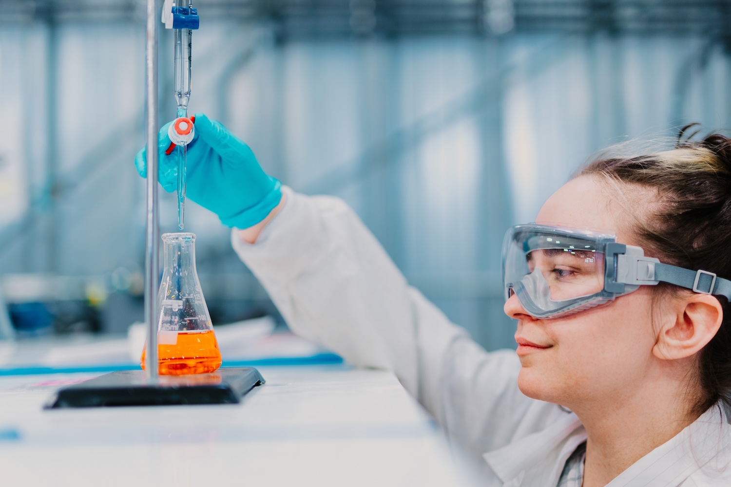 Worker examining beaker